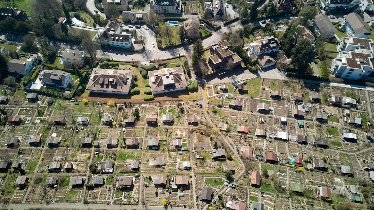 Drone shot of residential homes and gardens in sunny Zürich, Switzerland.